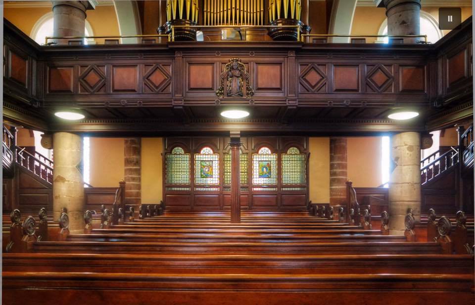 Congregation gathered in worship and prayer during a ministry service in Edmonton